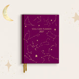 Purple planner with star constellations and 'Soul Care Planner 2027' text on a dark eggplant background